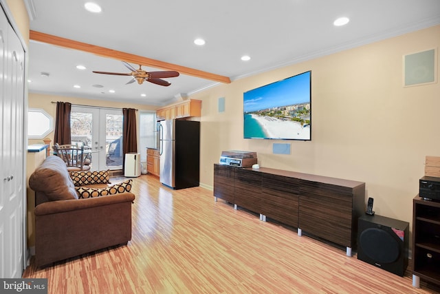 living room featuring french doors, ceiling fan, crown molding, and light wood-type flooring