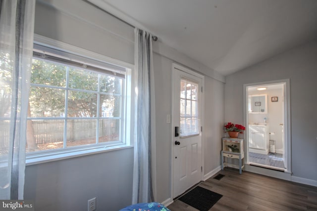 doorway featuring dark wood-type flooring and lofted ceiling