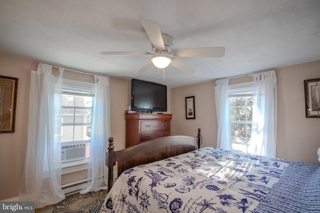 bedroom featuring multiple windows, cooling unit, ceiling fan, and baseboard heating