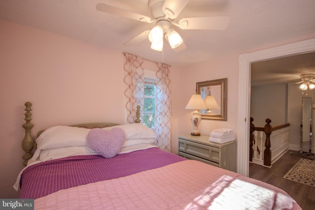 bedroom with dark hardwood / wood-style floors and ceiling fan