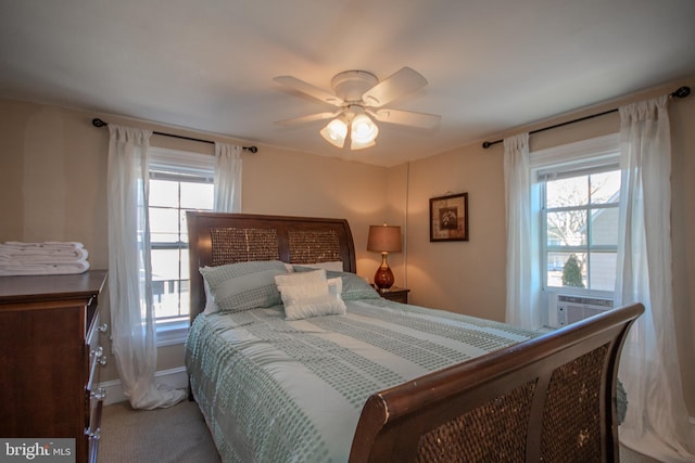 bedroom featuring multiple windows, carpet floors, cooling unit, and ceiling fan