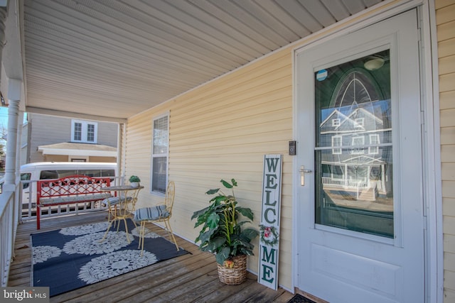 wooden terrace featuring covered porch