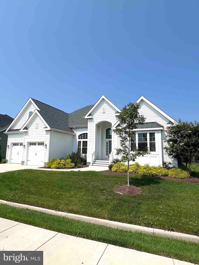single story home featuring an attached garage, driveway, and a front yard