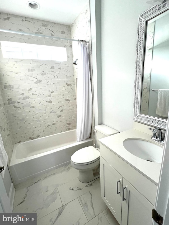 full bathroom featuring vanity, shower / bath combination with curtain, and toilet