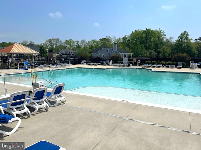 pool featuring a gazebo, fence, and a patio