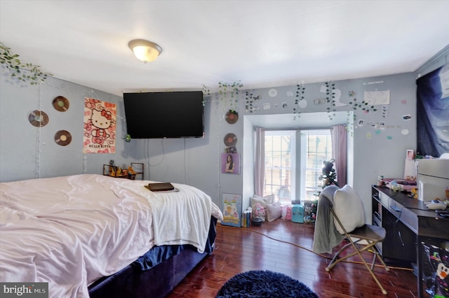 bedroom with dark hardwood / wood-style flooring