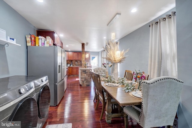 dining space with dark hardwood / wood-style flooring and separate washer and dryer