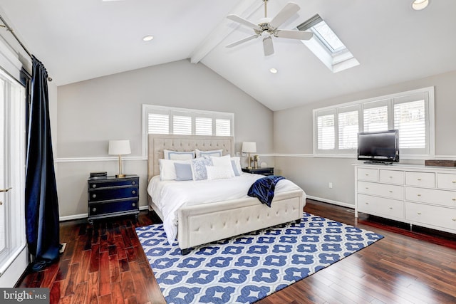 bedroom featuring dark hardwood / wood-style floors, vaulted ceiling with skylight, and ceiling fan