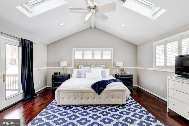 bedroom featuring access to exterior, dark hardwood / wood-style floors, vaulted ceiling with skylight, and ceiling fan