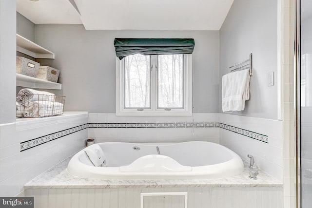 bathroom featuring tiled bath