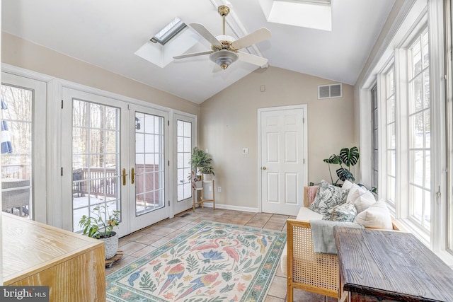 interior space with french doors, ceiling fan, and lofted ceiling with skylight