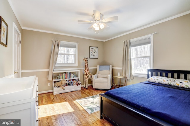 bedroom featuring crown molding, ceiling fan, and light wood-type flooring