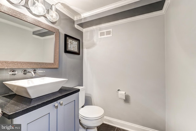 bathroom featuring vanity, crown molding, and toilet