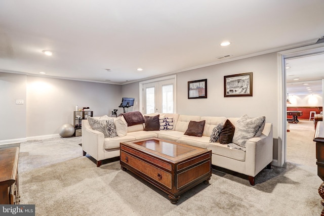 carpeted living room featuring crown molding and french doors