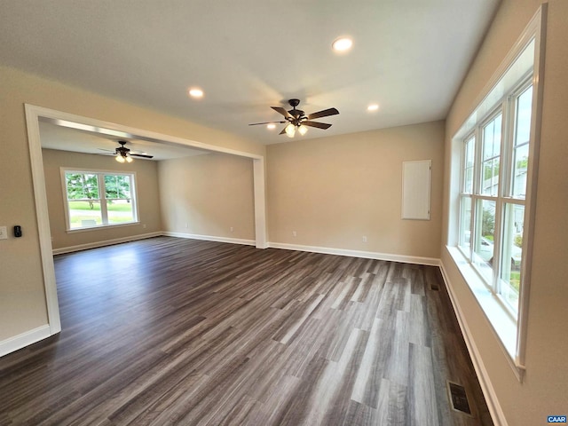 unfurnished room with dark hardwood / wood-style floors and ceiling fan