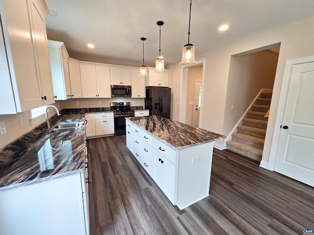 kitchen with white cabinetry, a center island, sink, and black appliances