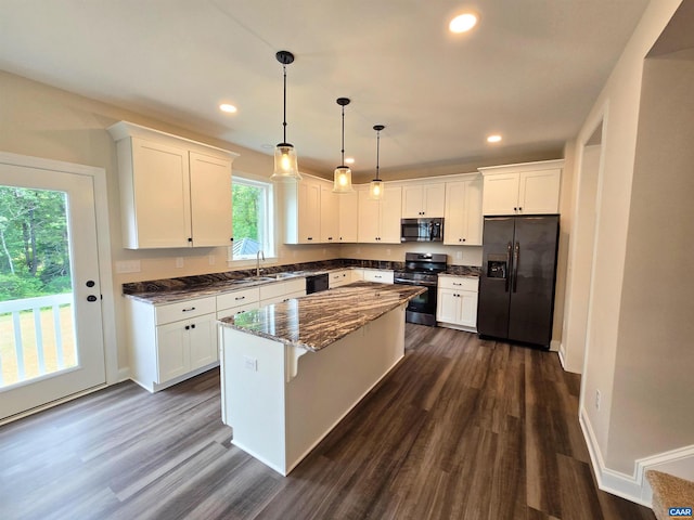 kitchen featuring pendant lighting, sink, black appliances, white cabinets, and a kitchen island