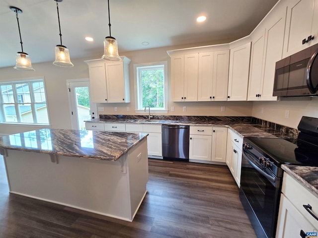 kitchen with black range with electric cooktop, decorative light fixtures, white cabinets, and dishwasher