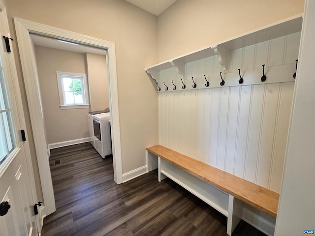 mudroom with dark wood-type flooring and washer and dryer