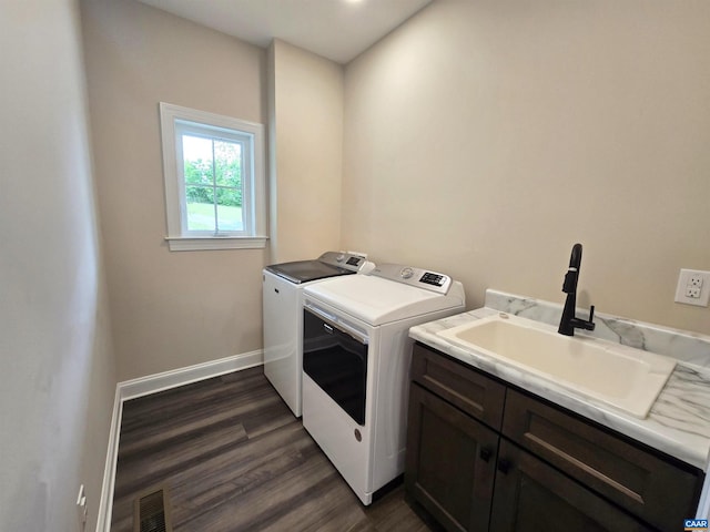 washroom with cabinets, separate washer and dryer, sink, and dark hardwood / wood-style flooring