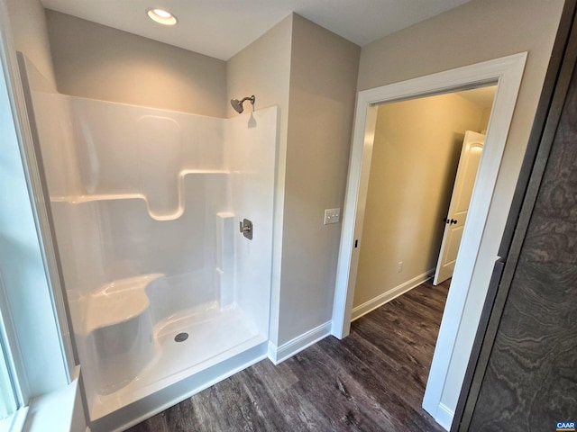 bathroom with walk in shower and hardwood / wood-style floors