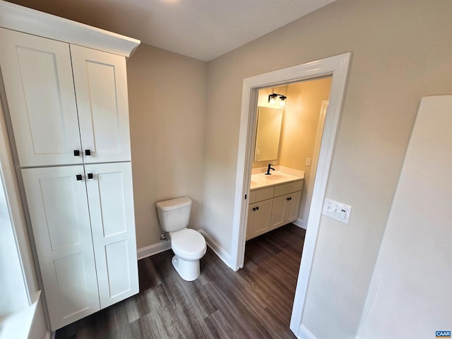 bathroom featuring hardwood / wood-style flooring, vanity, and toilet