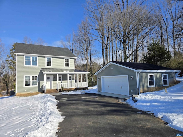 view of front of home with central AC, a garage, and covered porch