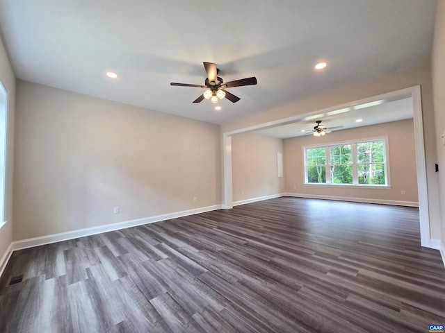 unfurnished room with ceiling fan and dark hardwood / wood-style flooring