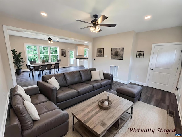 living room featuring hardwood / wood-style flooring and ceiling fan