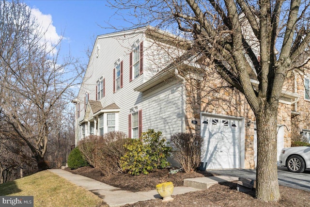 view of side of home featuring a garage