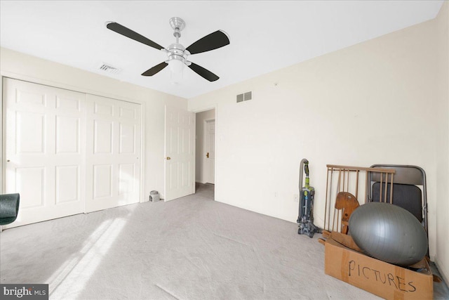 sitting room with ceiling fan and carpet flooring