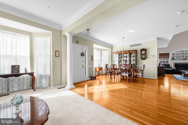 living room featuring hardwood / wood-style floors, plenty of natural light, and decorative columns