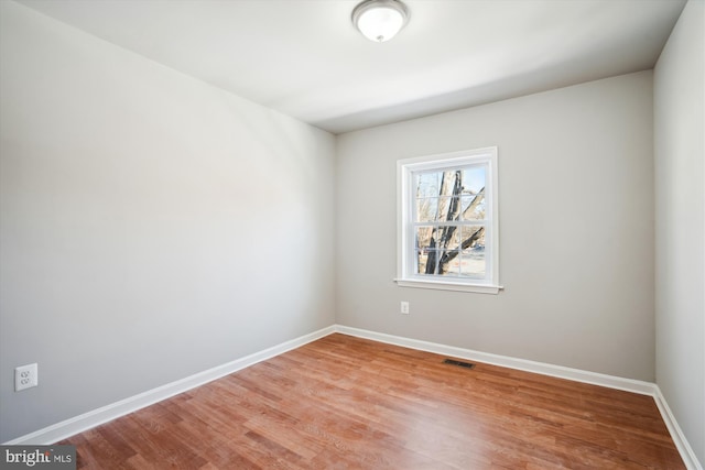 spare room with light hardwood / wood-style flooring