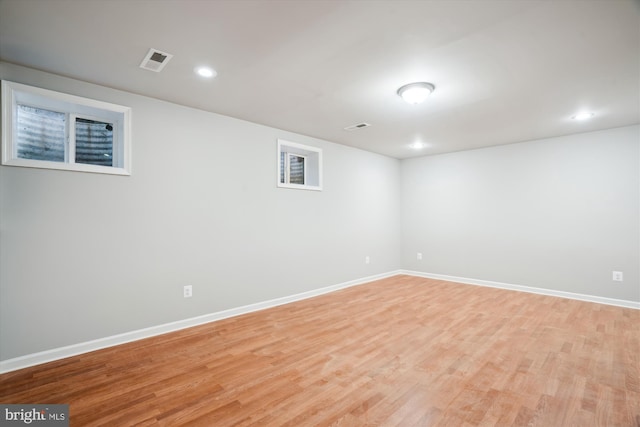 basement with light hardwood / wood-style flooring