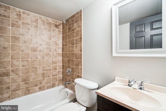 full bathroom with vanity, toilet, and tiled shower / bath