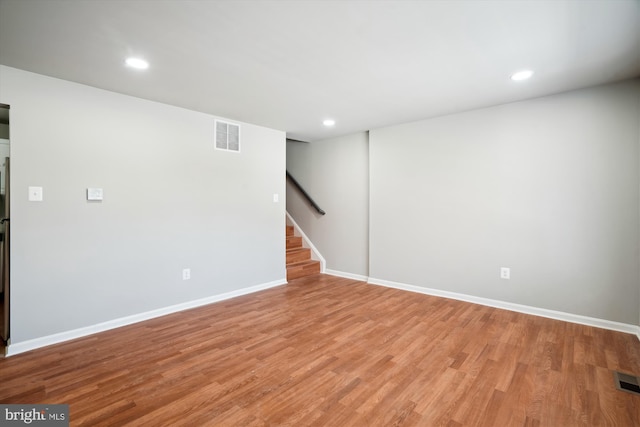 basement with light hardwood / wood-style floors