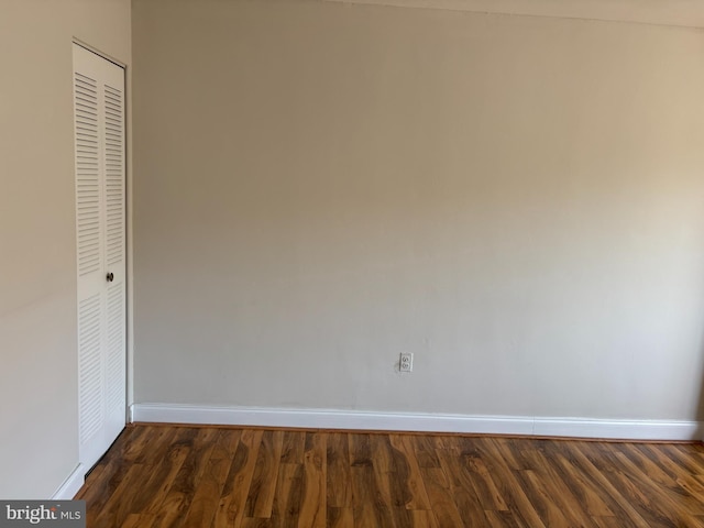 interior space featuring dark hardwood / wood-style flooring and a closet