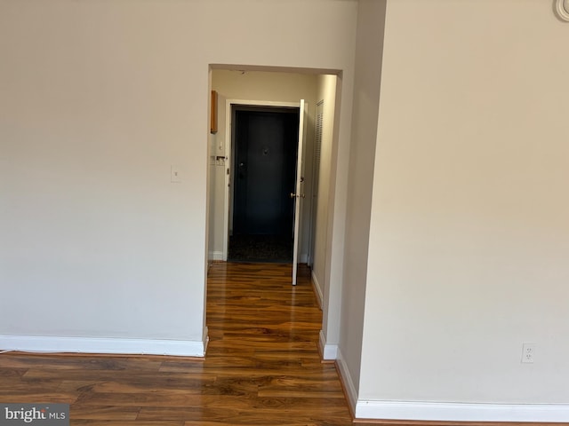 corridor with dark hardwood / wood-style floors