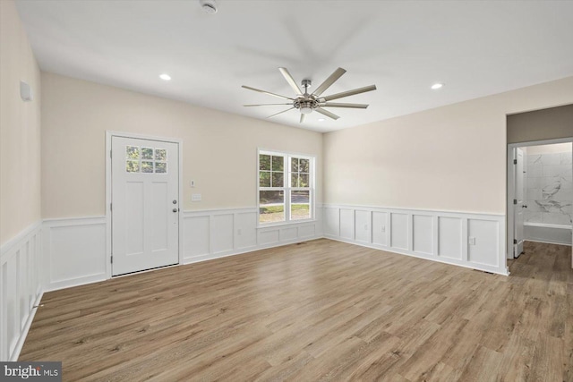 interior space with ceiling fan and light hardwood / wood-style flooring