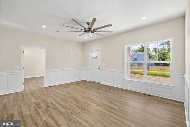 empty room featuring light hardwood / wood-style flooring and ceiling fan