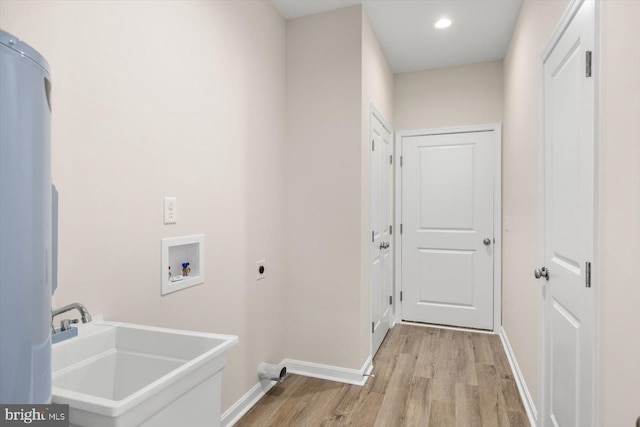 clothes washing area featuring washer hookup, sink, hookup for an electric dryer, and light wood-type flooring