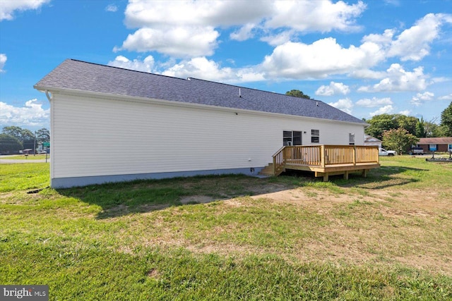 back of house with a yard and a deck