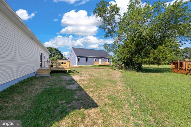 view of yard featuring a wooden deck