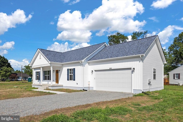 view of front of property featuring a garage and a front lawn