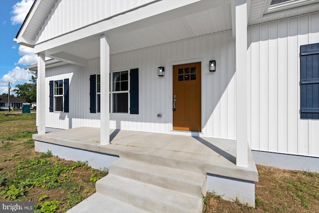 view of exterior entry with a porch