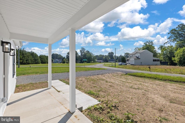 view of yard featuring covered porch