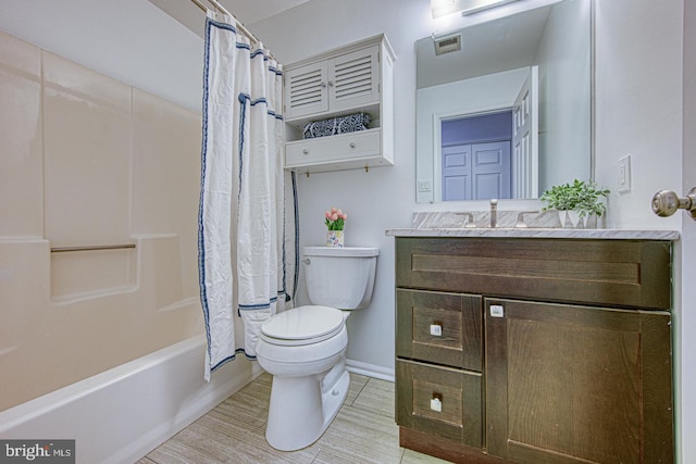 bathroom featuring shower / bath combo, visible vents, toilet, wood finished floors, and vanity