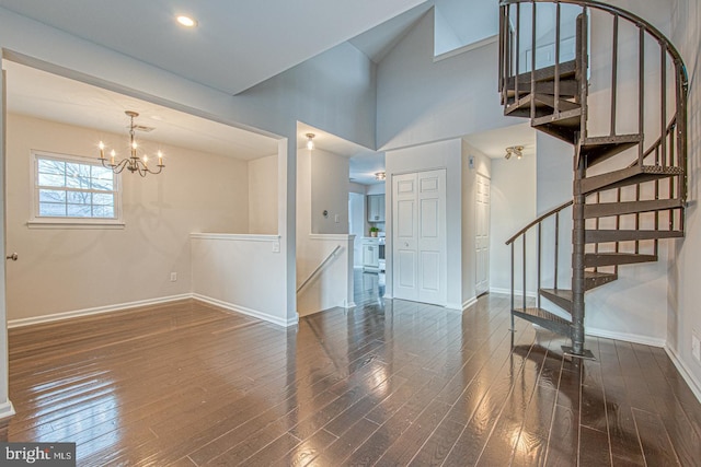 entryway with stairs, baseboards, a chandelier, and dark wood-type flooring