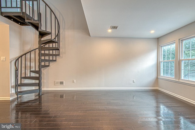 interior space featuring dark wood-style floors, recessed lighting, visible vents, baseboards, and stairs