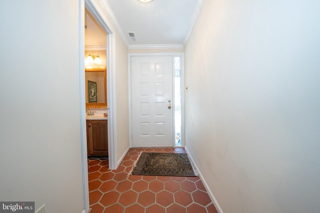 entryway featuring ornamental molding and sink